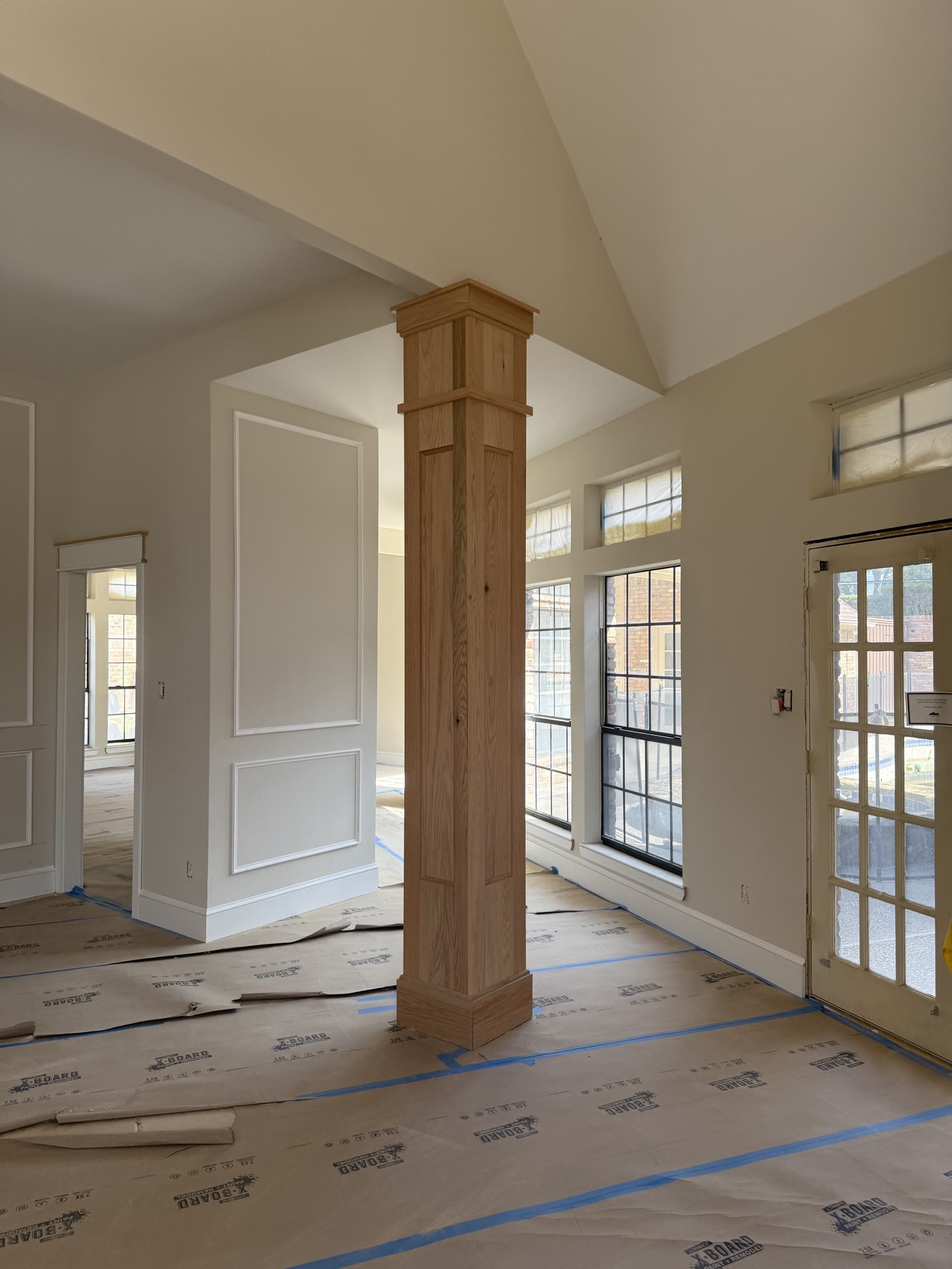 Finished custom wood column and wainscoting in a home entryway