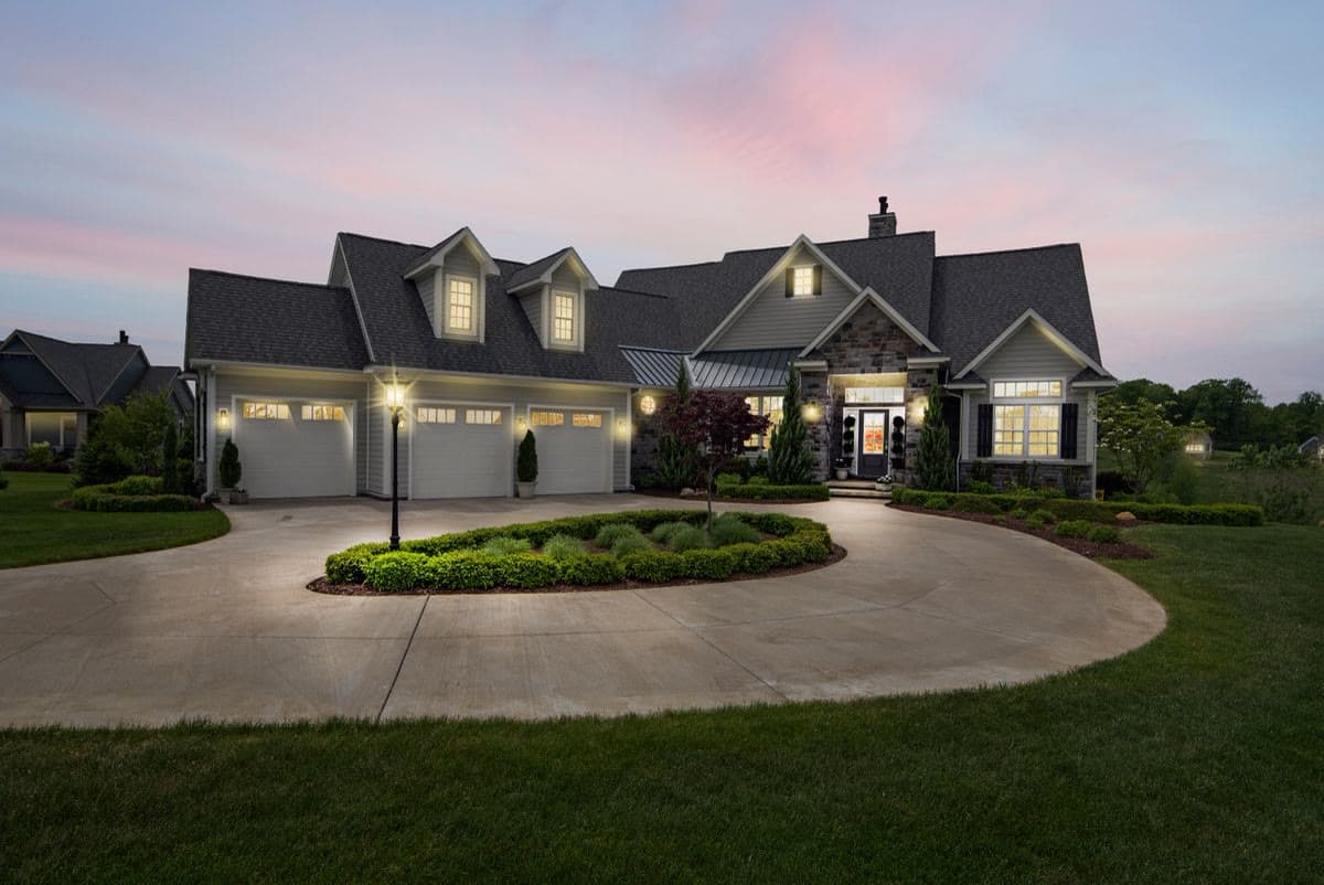 Beautifully lit suburban home exterior at dusk