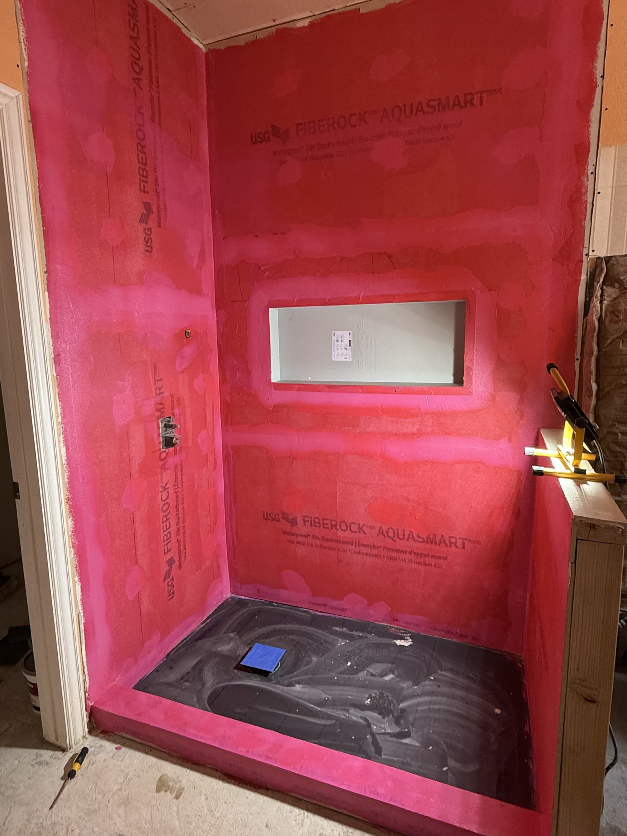 Shower alcove with waterproof membrane board installed before tiling begins