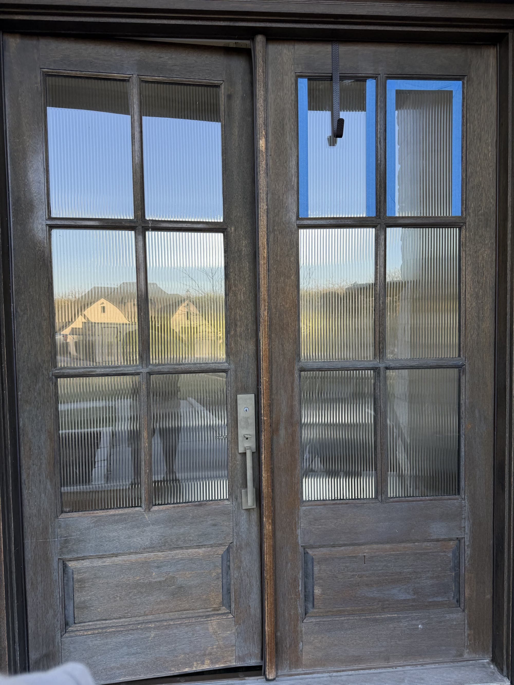 Weathered wood double entry doors before staining and refinishing