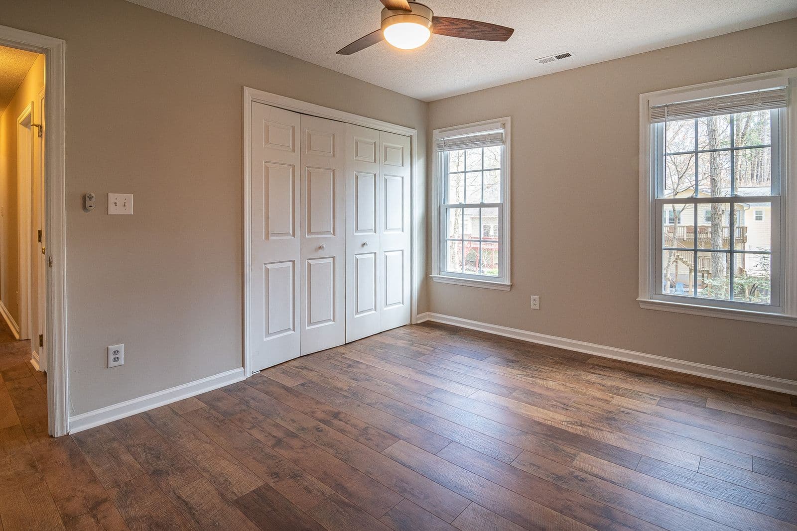 Spacious room with newly installed hardwood flooring and natural light